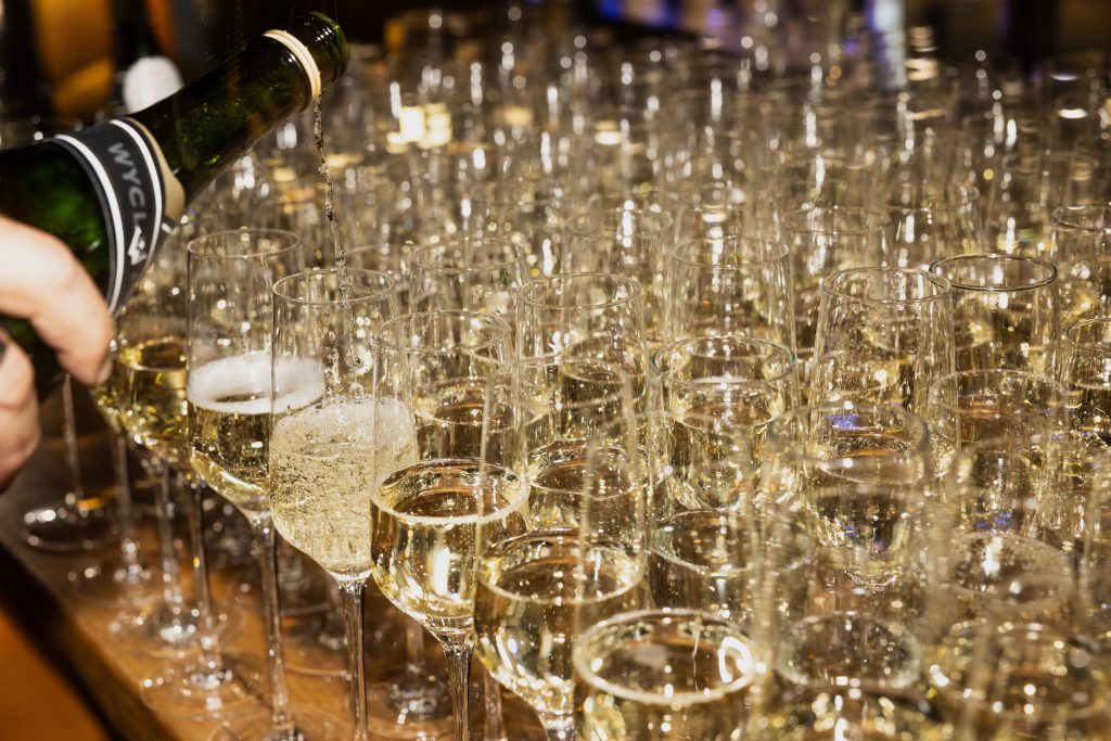 Bartender pouring champagne into many different glasses for a New Years Eve celebration at Vidrio, in Downtown Raleigh, 2023.