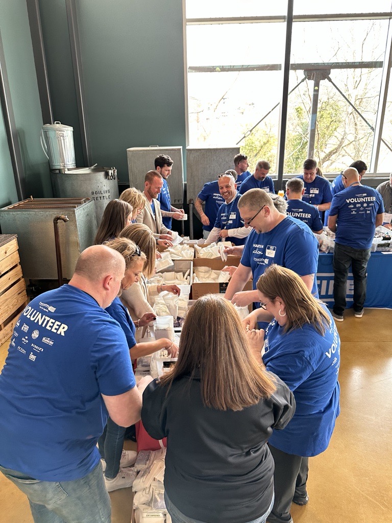 LM Restaurants Teams working together to help build safety packs for the Asheville community through BeLoved Asheville NC.