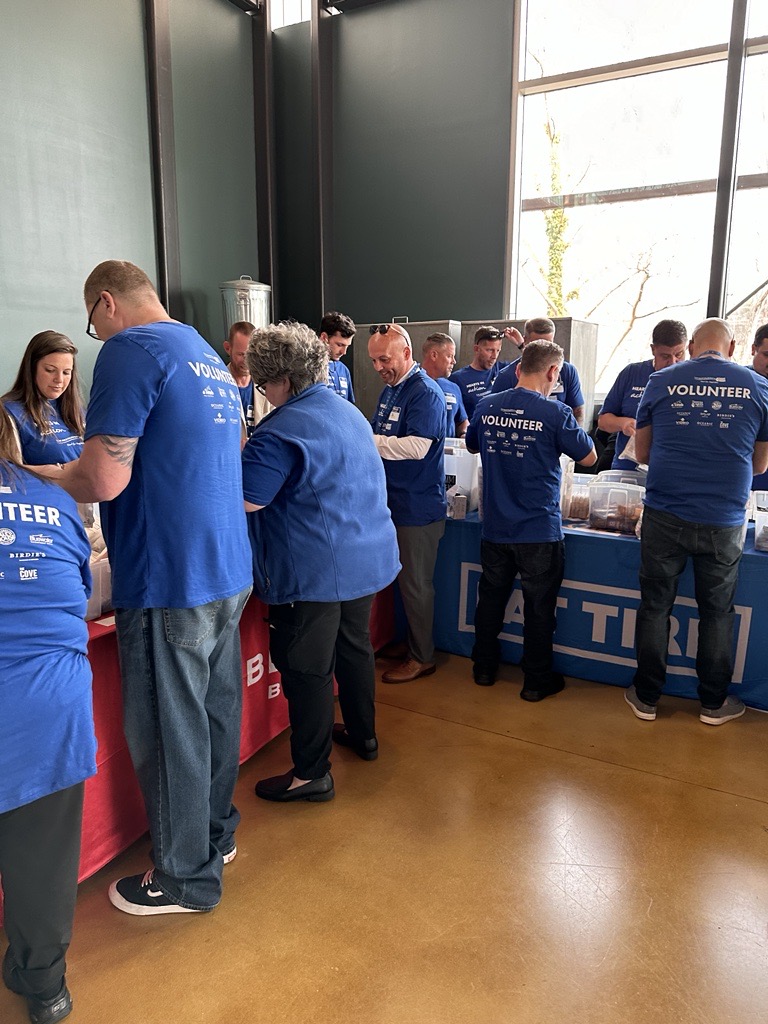 LM Restaurants Teams working together to help build safety packs for the Asheville community through BeLoved Asheville NC.