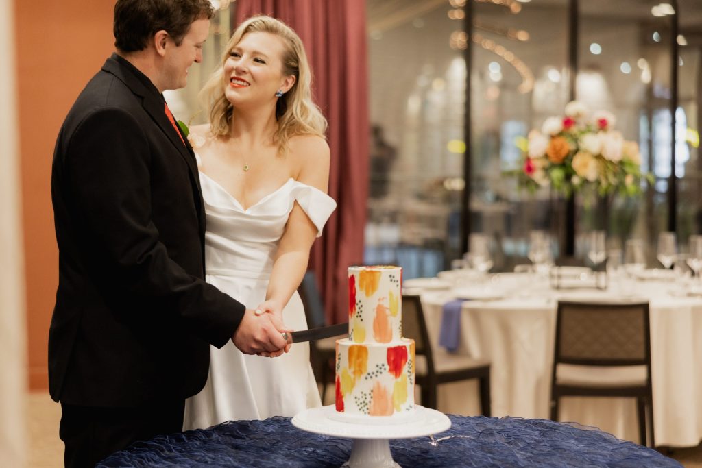 Vidrio Raleigh - Upstairs private event space with models cutting their wedding or rehearsal dinner cake