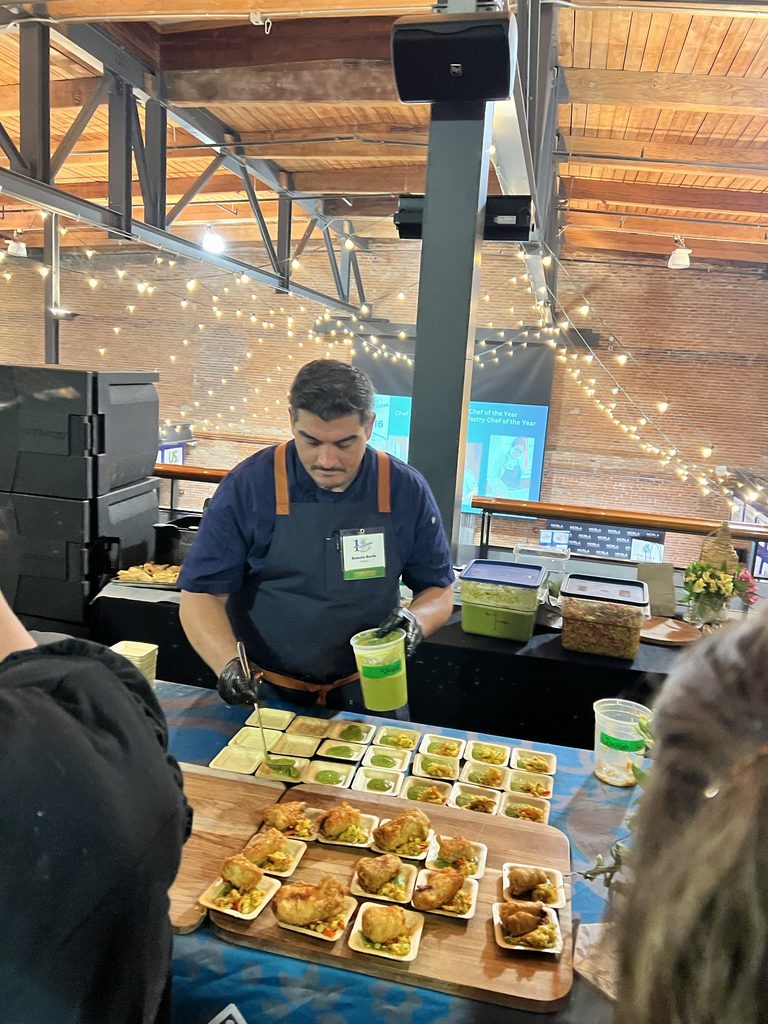 Chef Roberto passing out dish samples at the NCRLA Chef Showdown in 2026.