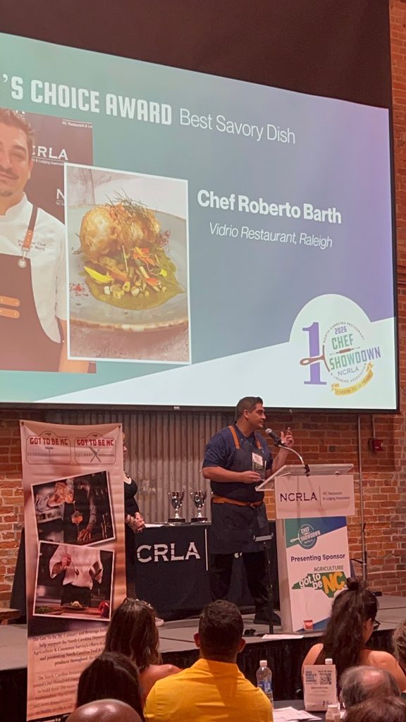 Chef Roberto accepting his award on stage at the NCRLA Chef Showdown in 2026.